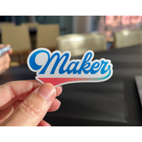 Vinyl sticker reading Maker in a script font