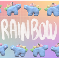 Alternating stegosaurus charms arranged in two rows along the top and bottom of the image. All of the charms are pastel blue with rainbow-colored back plates, but two have white eyes and the other two have pastel purple eyes. "Rainbow" is handwritten in white in the middle of the image between the two rows. The background is an unevenly faded white grid overlaying a pastel rainbow gradient.