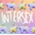 Two stegosaurus charms placed in an alternating pattern across two rows on the top and bottom of the image. One charm is pastel purple with pastel yellow back plates. The other is pastel yellow with pastel purple plates. "Intersex" is handwritten in white in the middle of the image between the two rows. The background is an unevenly faded white grid overlaying a pastel rainbow gradient.