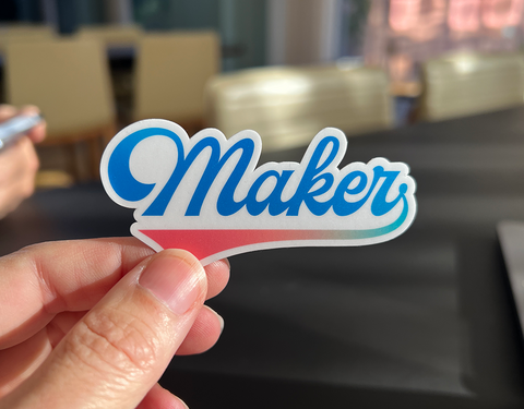 Vinyl sticker reading Maker in a script font