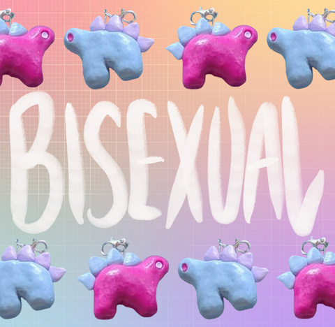Stegosaurus charms placed in an alternating pattern along two rows on the top and bottom of the image. One charm is magenta with pastel blue back plates and pastel purple eyes. The other is pastel blue with pastel purple plates and magenta eyes. "Bisexual" is handwritten in white in the middle of the image between the two rows. The background is an unevenly faded white grid overlaying a pastel rainbow gradient.