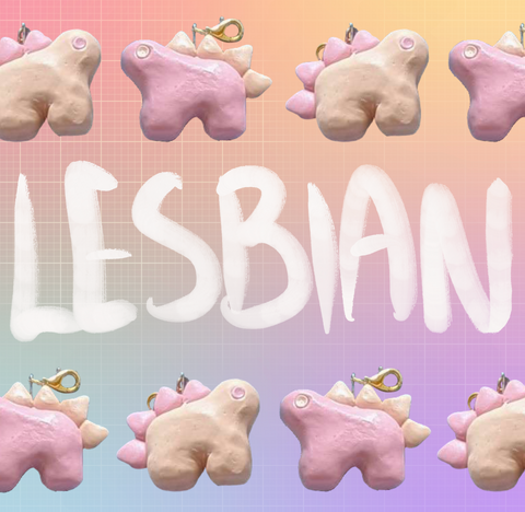 Alternating stegosaurus charms arranged in two rows on the top and bottom of the image. One is pastel orange with light pink back plates and eyes. The other is light pink with pastel orange plates and eyes. "Lesbian" is handwritten in white in the middle of the image between the two rows. The background of the image is an unevenly faded white grid overlaying a pastel rainbow gradient.