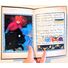 Photo of an open copy of the zine. The right page is text with marginalia on it and the left page is a full-page illustration with one of the figures blocked out with acrylic paint.