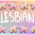 Alternating stegosaurus charms arranged in two rows on the top and bottom of the image. One is pastel orange with light pink back plates and eyes. The other is light pink with pastel orange plates and eyes. "Lesbian" is handwritten in white in the middle of the image between the two rows. The background of the image is an unevenly faded white grid overlaying a pastel rainbow gradient.